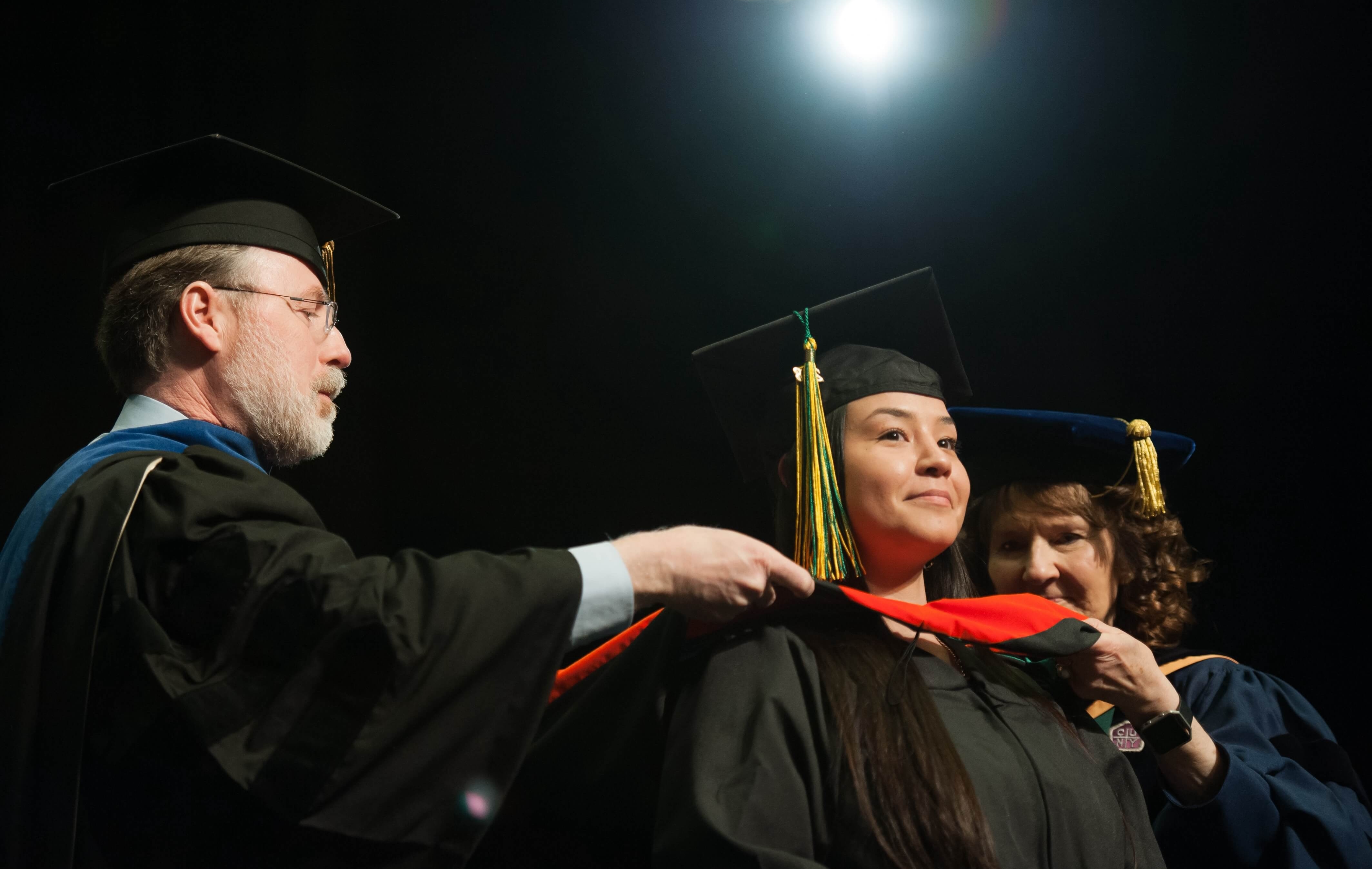 Forest Rose Walker recieves her hood at the Graduate Degree Hooding Ceremony in 2018.