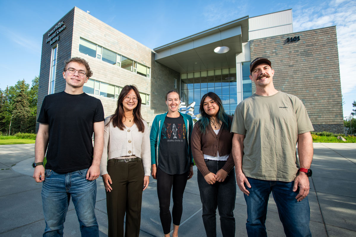 The initial cohort of UAA and WWAMI's new NIH-funded Biomed U-RISE program, photographed outside UAA's ConocoPhillips Integrated Science Building. From left: Bryce Inman, Hanna Whang, Holly Martinson (co-PI), Alyssa Samson, and Steven Cherry.