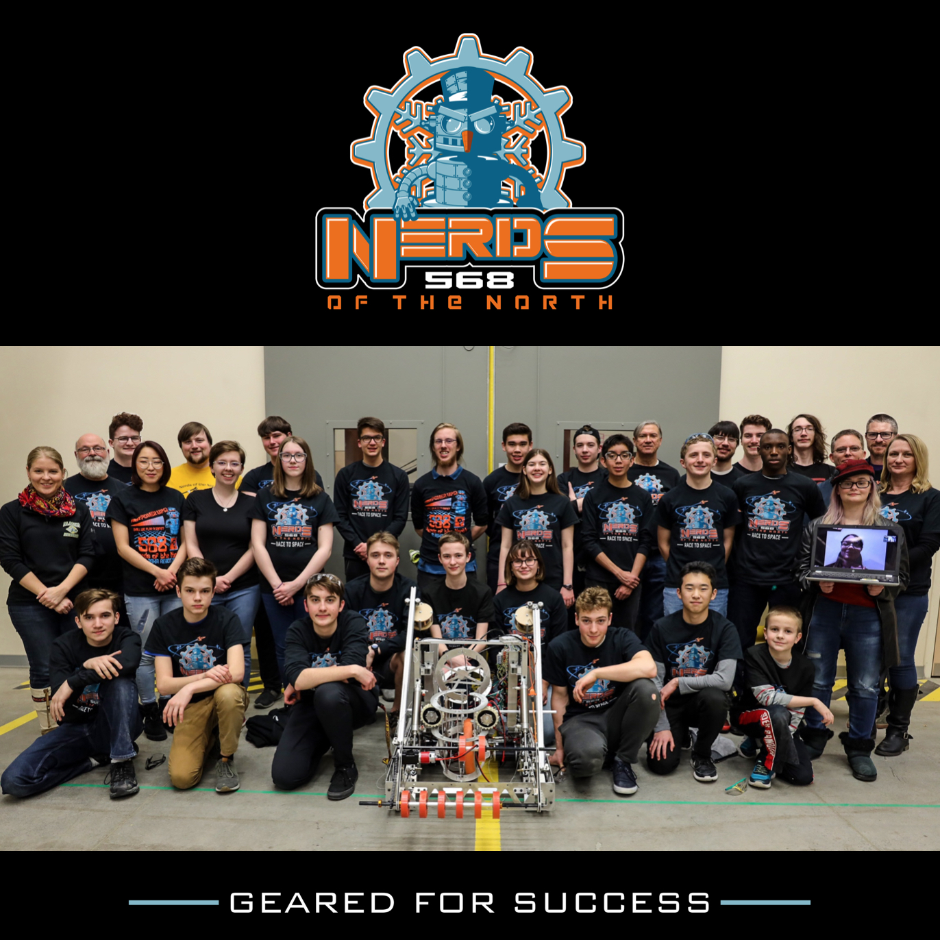 group photo of robotics team with robot