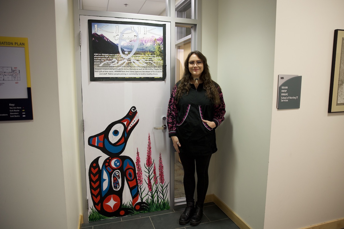 Kyla Turner standing next to artwork