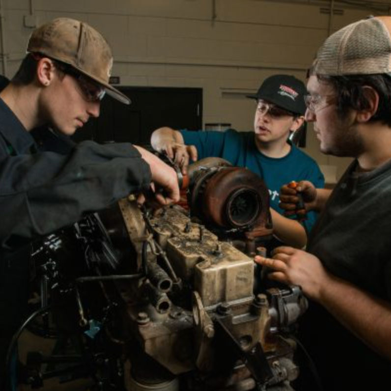 Students working on an engine block