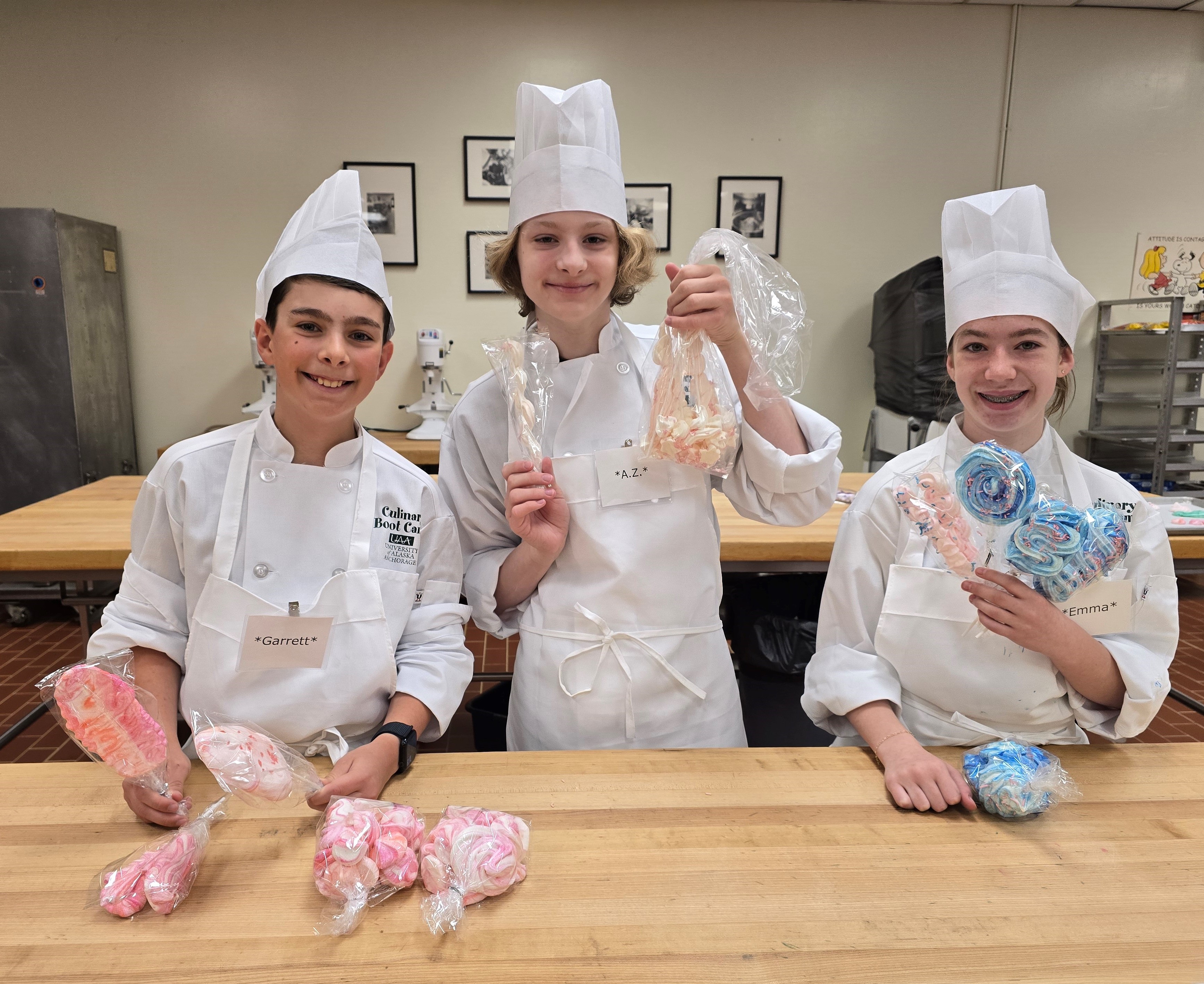 3 students holding up meringues