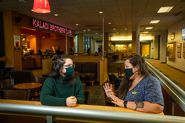 Seawolf mentor, Program Management masters grad and UAA Alumni Association board member Jessica Jacobsen meets with her protégé, Project Management masters student Maicel Fuhriman in the Kaladi Brothers Coffee shop outside UAA's Social Sciences Building.