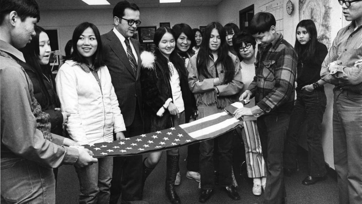 Ted Stevens and a class of Alaska Native high school students folding an American flag