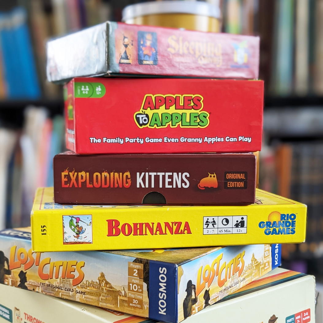 A stack of various board games.