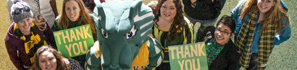 UAA students holding Thank You signs