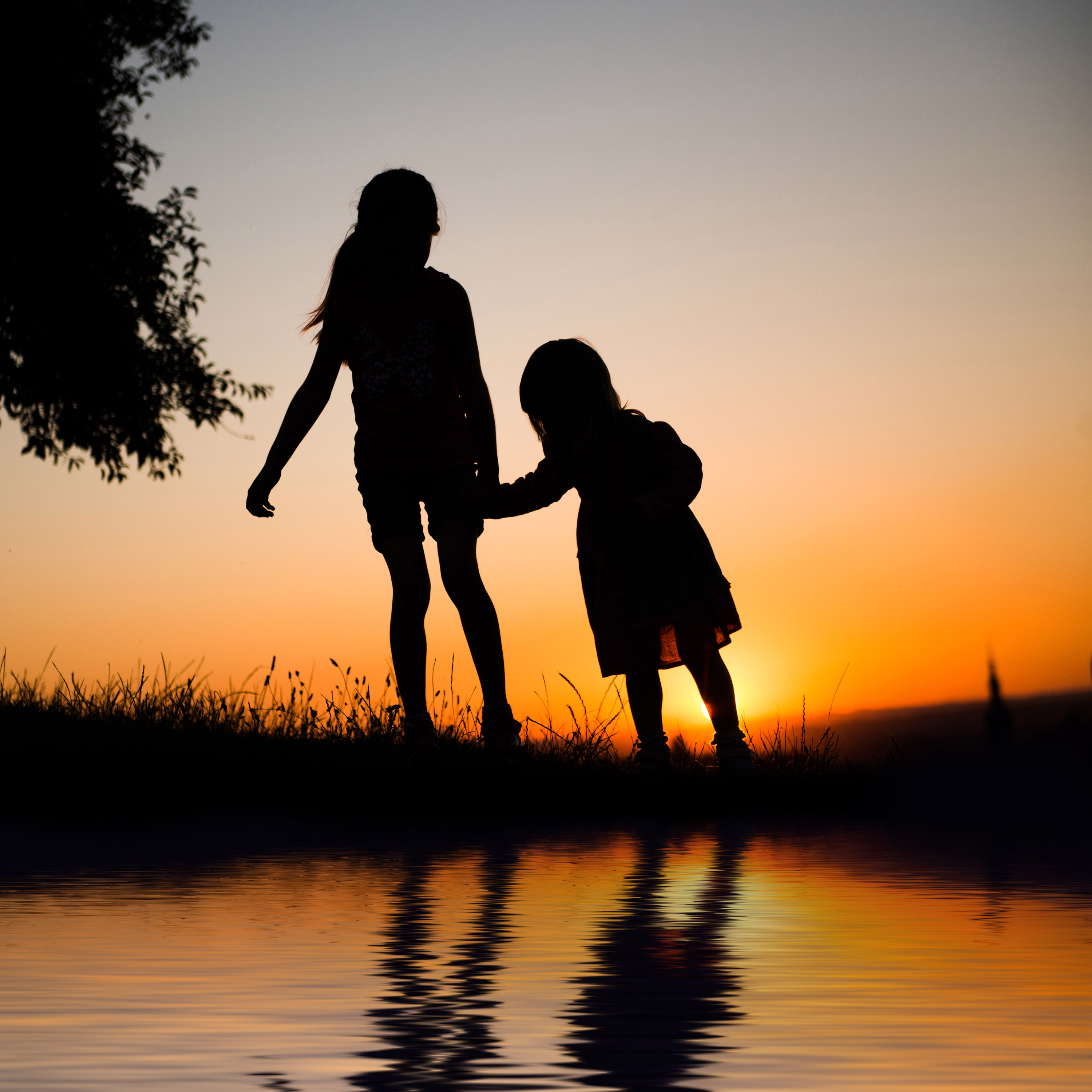 Two childeren holding hands outside