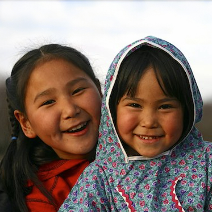 Two childeren smiling outside