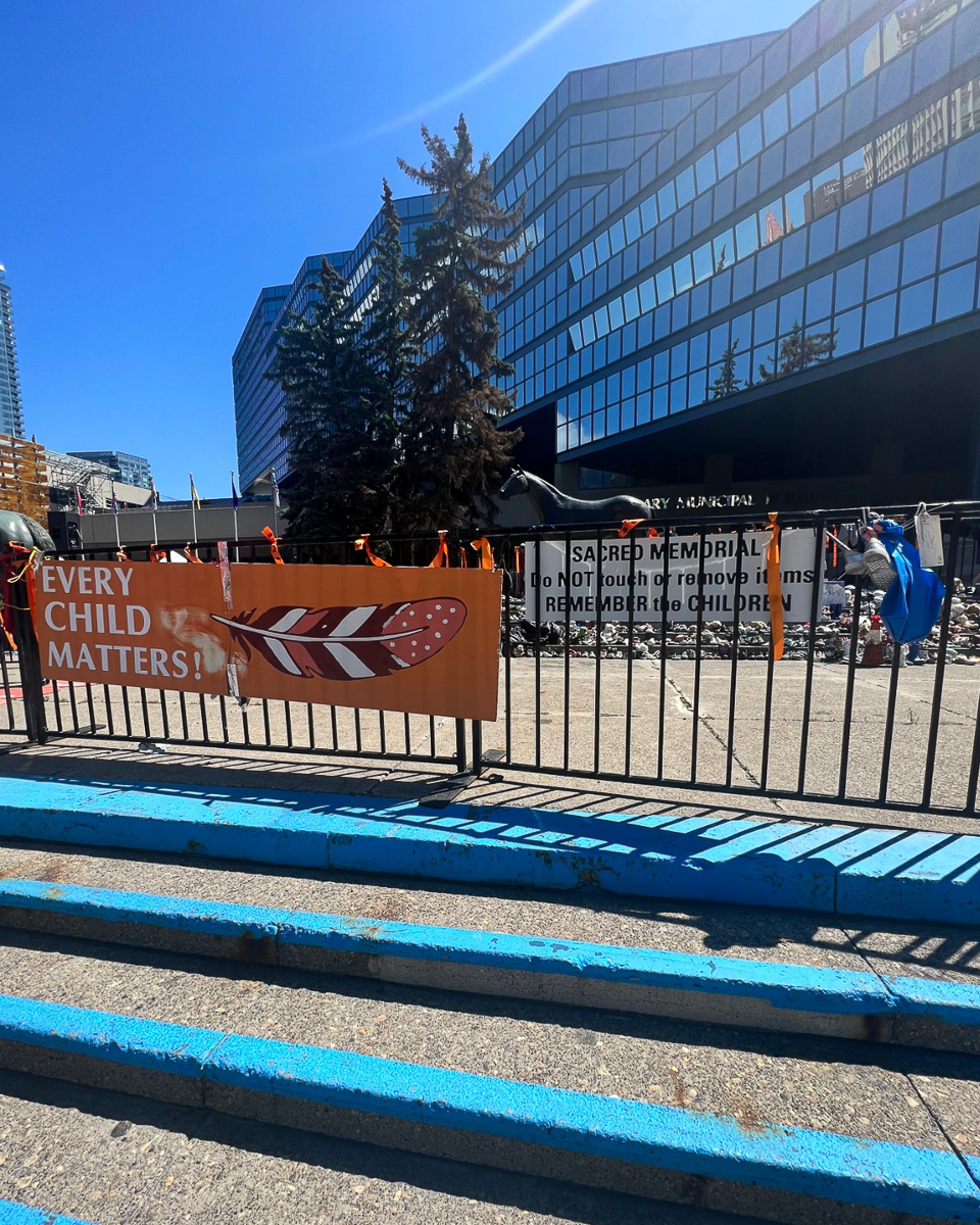 outdoor sign on fence reading "every child matters"