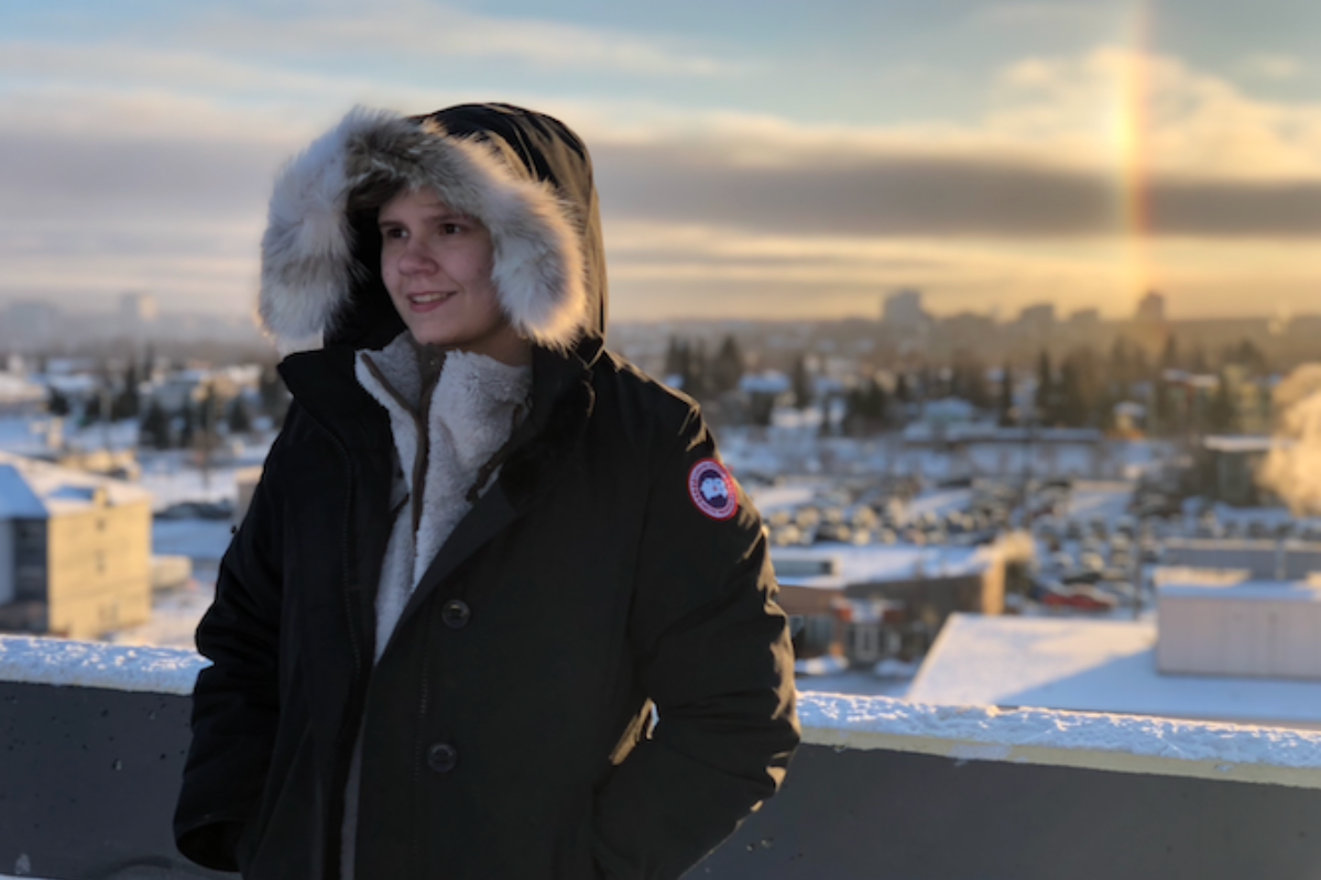 Briana Moffat, UAA School of Justice and Human Services alumna posed with puffy coat in winter weather