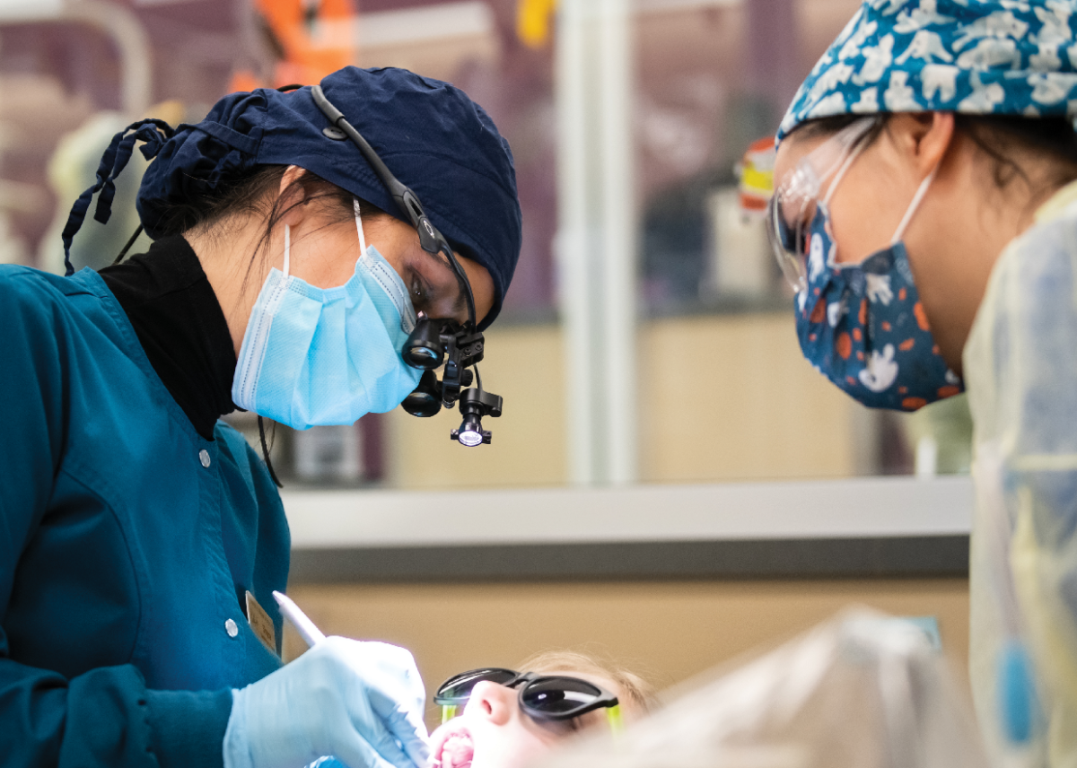 Dental hygiene students at UAA performing a teeth cleaning on a patient.