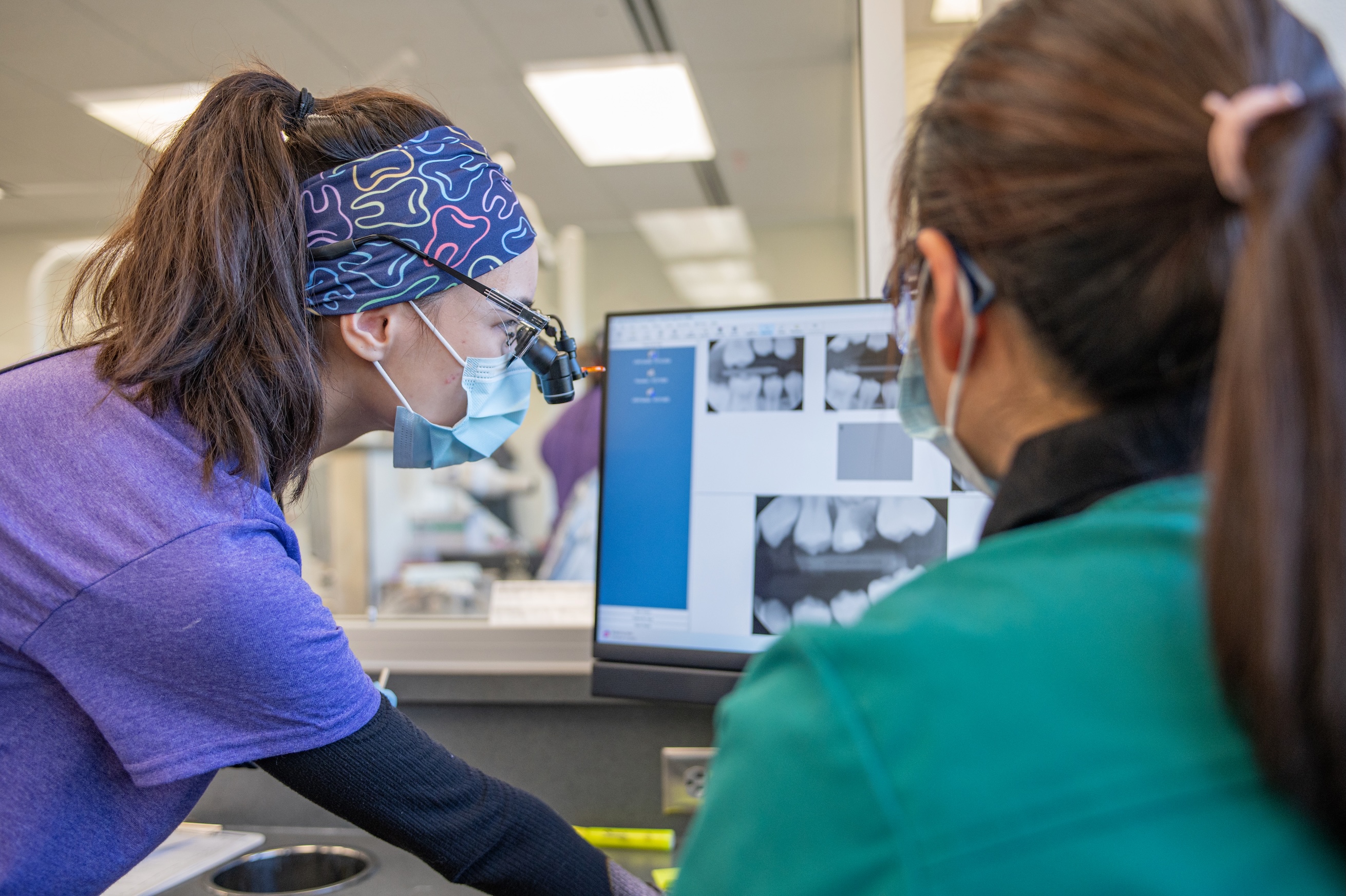 UAA dental hygiene student Michelle Duot-Kelley examines x-rays at the UAA Dental Clinic during the Cares for Kids event on October 18, 2024.