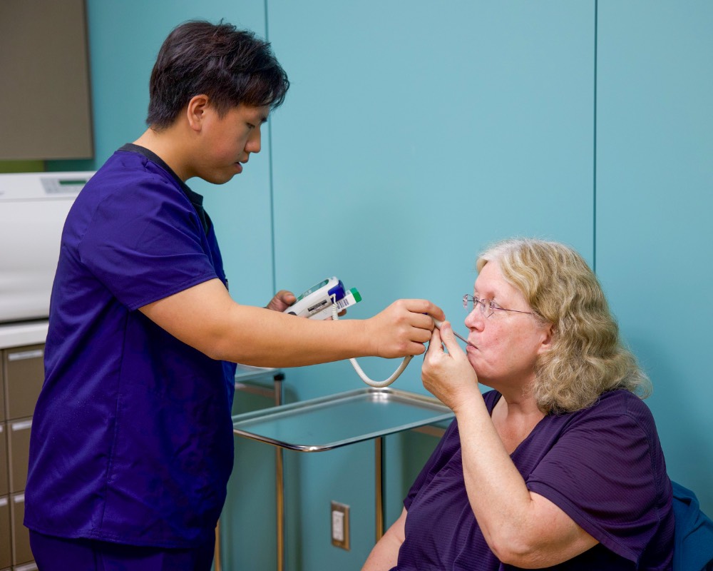 medical assisting student practices with standarized patient during simulation training