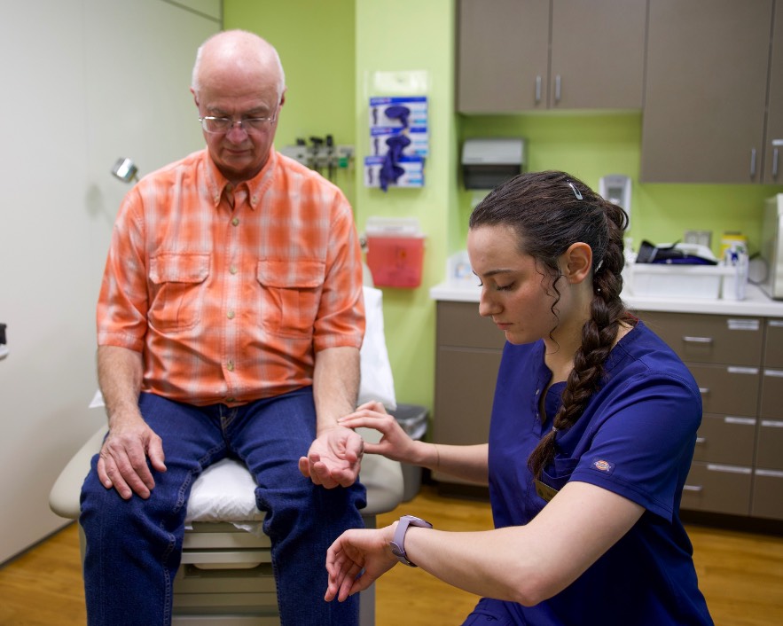 medical assisting student practices with standarized patient during simulation training