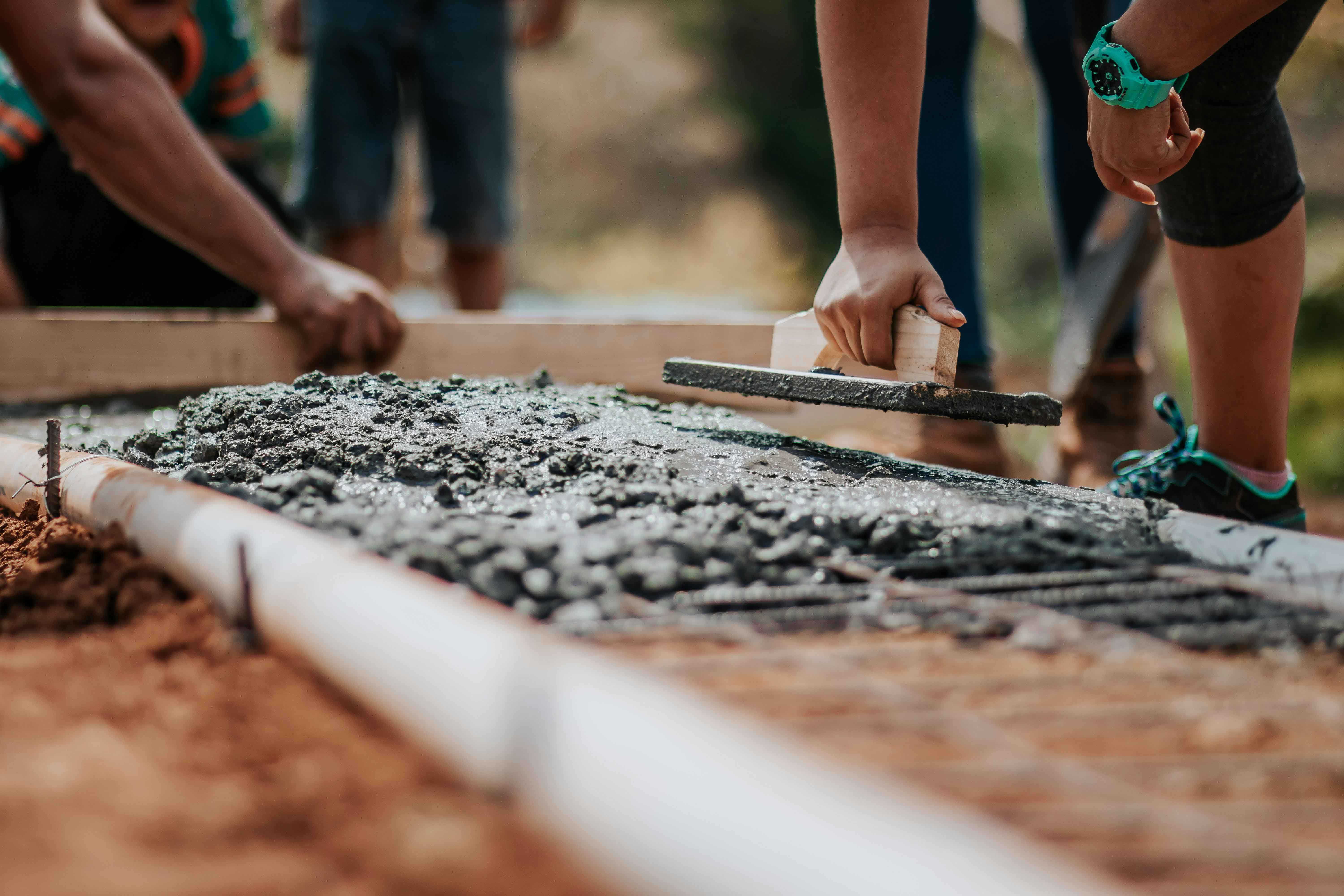 hands smoothing wet cement