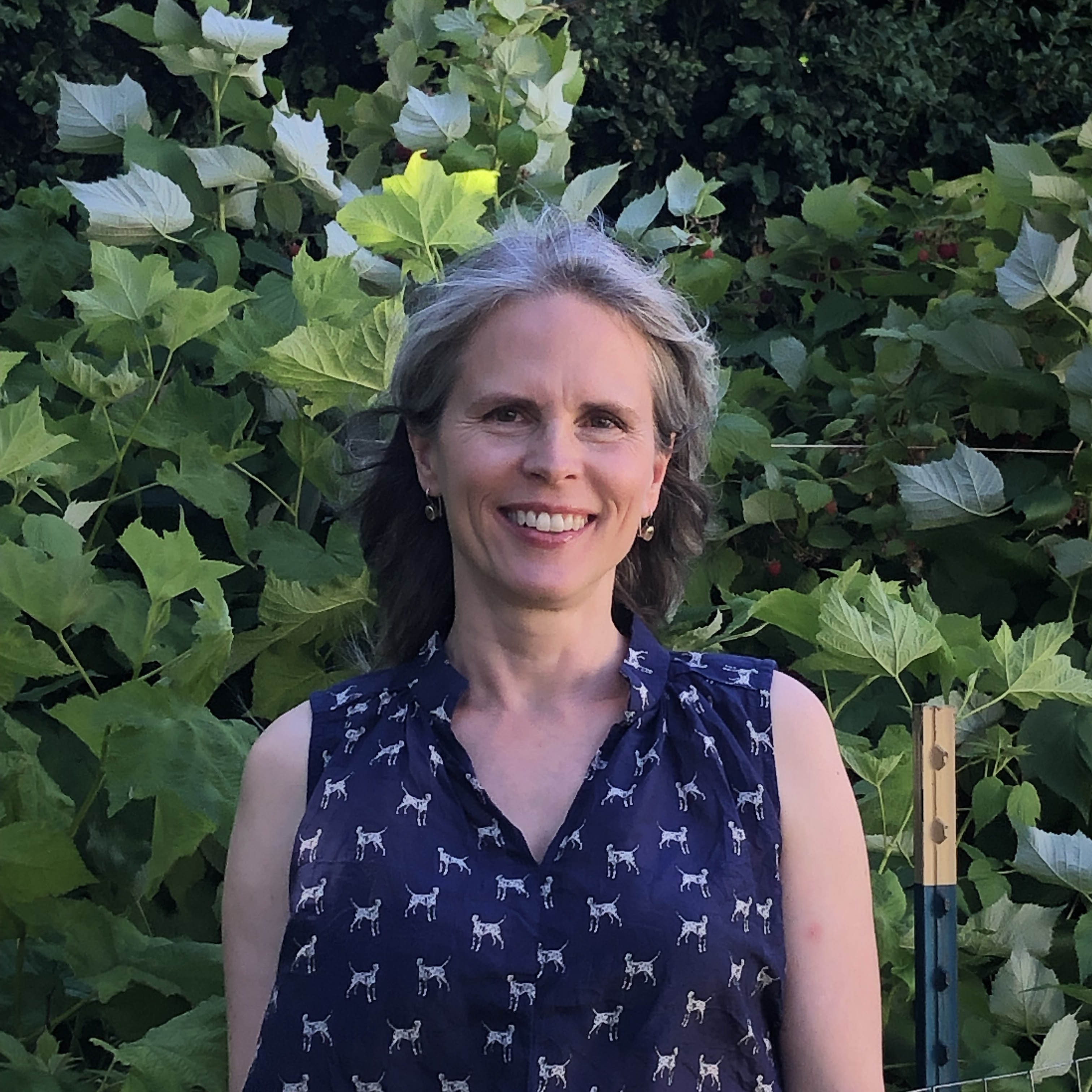 debra pennington davis smiling in front of tree