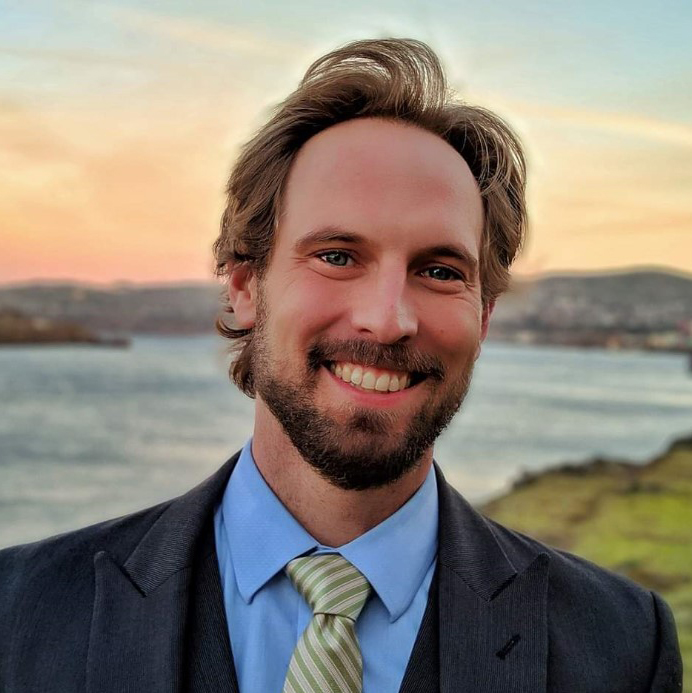 DA Matt Ellis smiling in front of beach