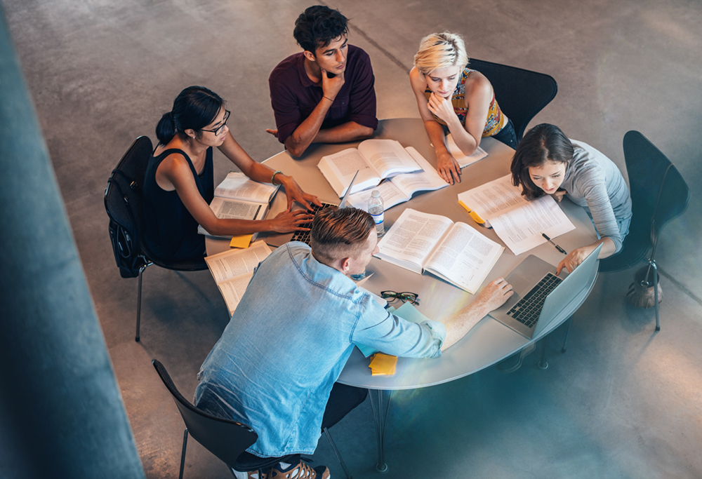 group of people studying at table