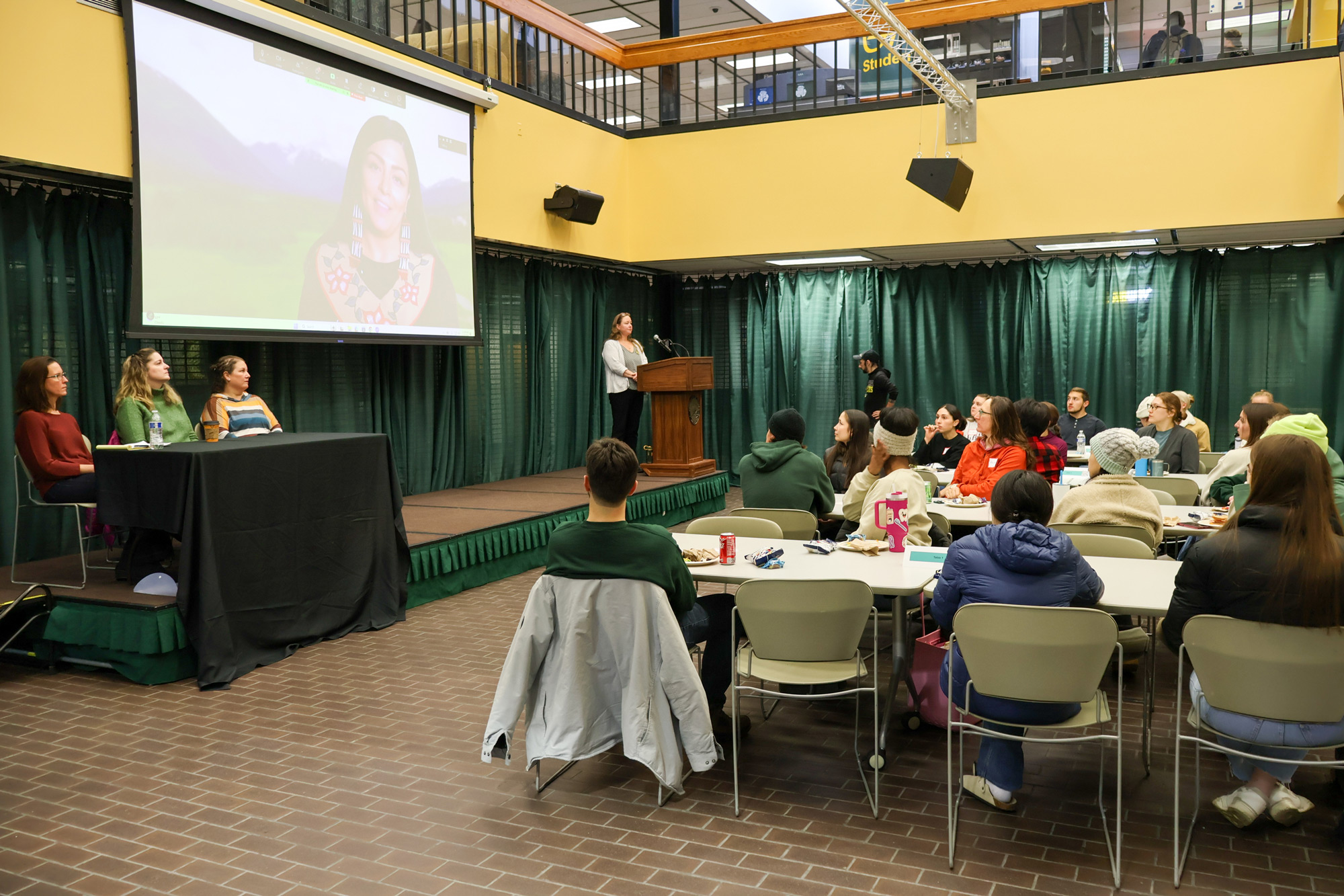 Students watch as Jessica Ross MEdTL, RDH delivers a land acknowledgment on screen during the 2024 Fall Grand Rounds on Nov. 8, 2024, at the University of Alaska Anchorage. (Photo by Kevin Bennett, UAA Alaska Center for Rural Health & Health Workforce)