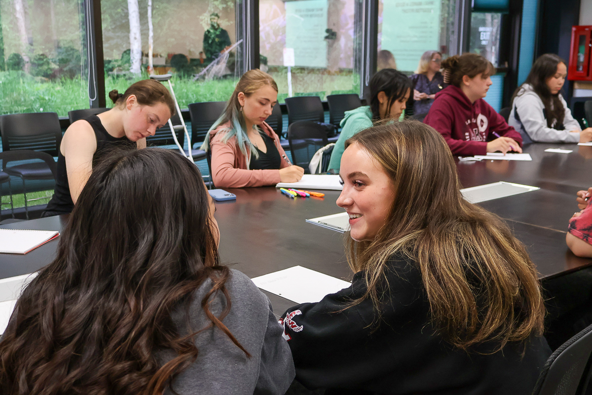 Della Keats students in conference room collaborating on project