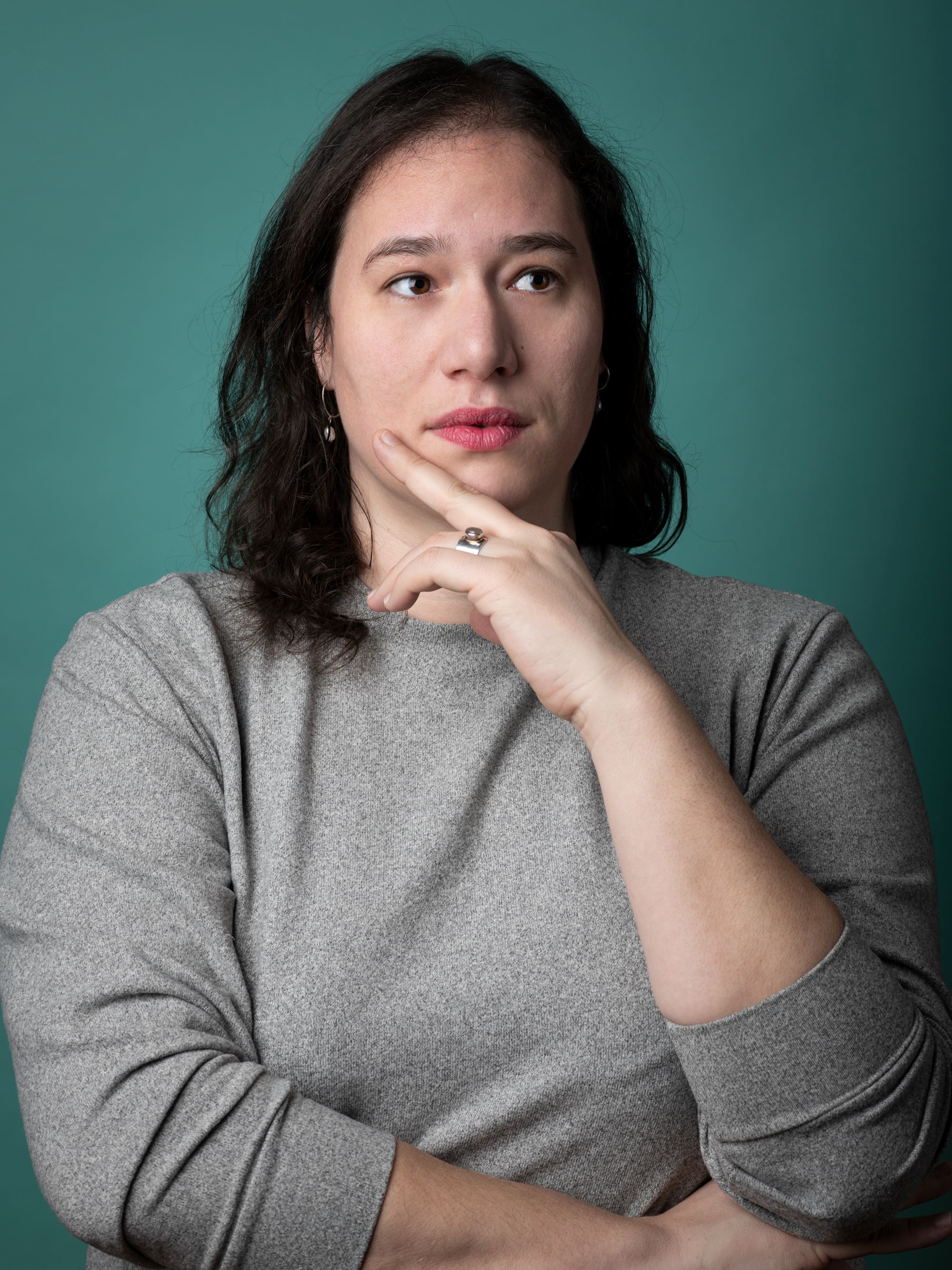 a headshot of Katja Perat, wearing a gray sweater