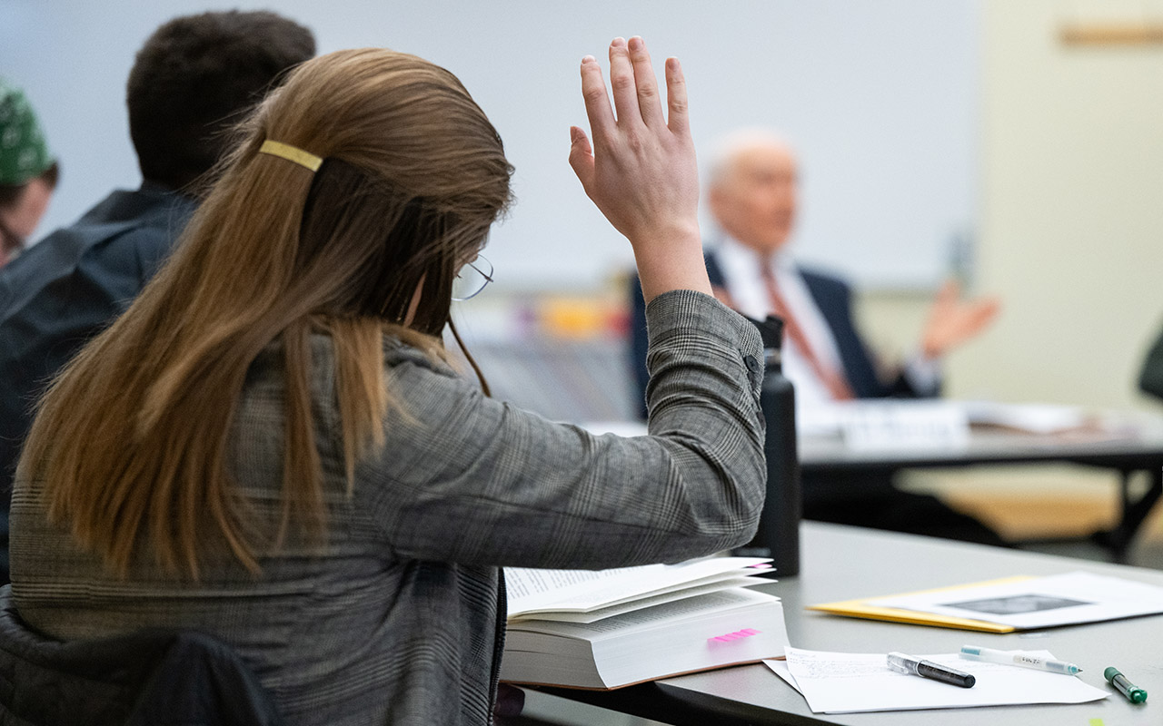 student raising hand