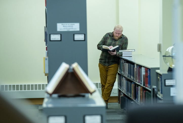 library faculty member holding a book