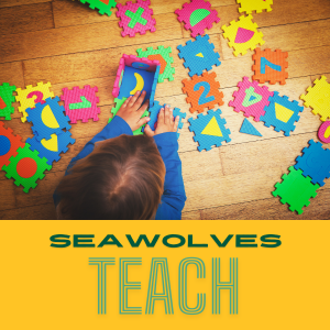 a child plays with letter tiles spread out on the floor