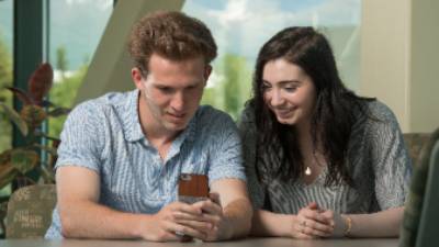 Students looking at a phone