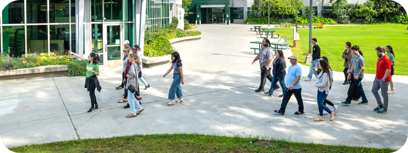 People taking of a tour of campus outside in the summer