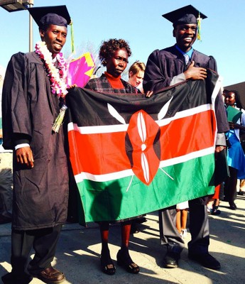 Micah Chelimo, left, poses with his mother, Flora Kabon Chelimo, fellow UAA runner Isaac Kangogo and the flag of Kenya, after the two men graduated Sunday. Photo by Robert Wendell Arnold