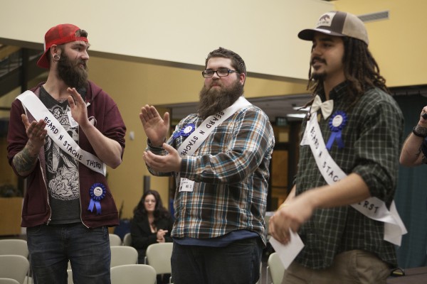 The top three finishers at the 2015 UAA Beard and 'Stache Competition, from left to right: Kyle Roll (baby beard winner, third place overall), Eric Willis (grizzly beard winner, second place overall) and Devin Johnson (freestyle beard winner and best in show). (Photo by Philip Hall/University of Alaska Anchorage).