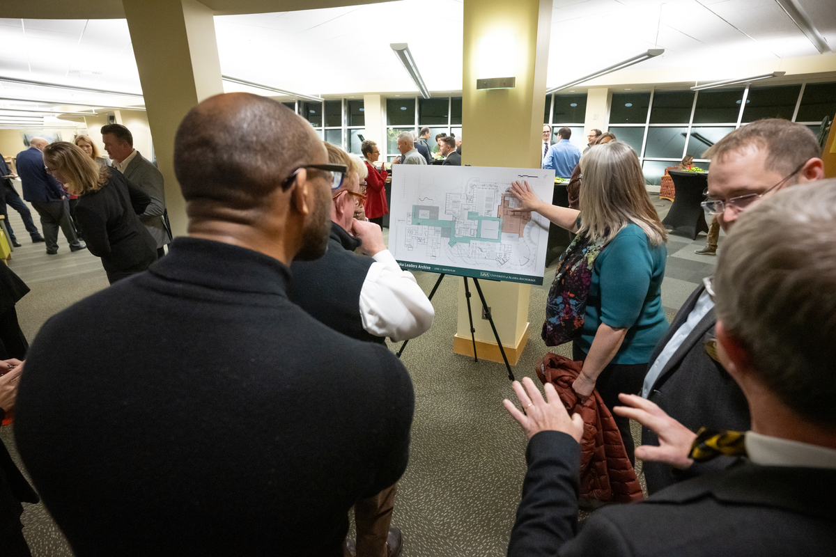 Associate Vice Chancellor of Facilities and Campus Services Kim Mahoney discusses plans for the new library expansion with guests as UAA announces a $2 million donation from ConocoPhillips Alaska to the Ted Stevens Foundation to create the Alaska Leaders Archive at the UAA/APU Consortium Library.