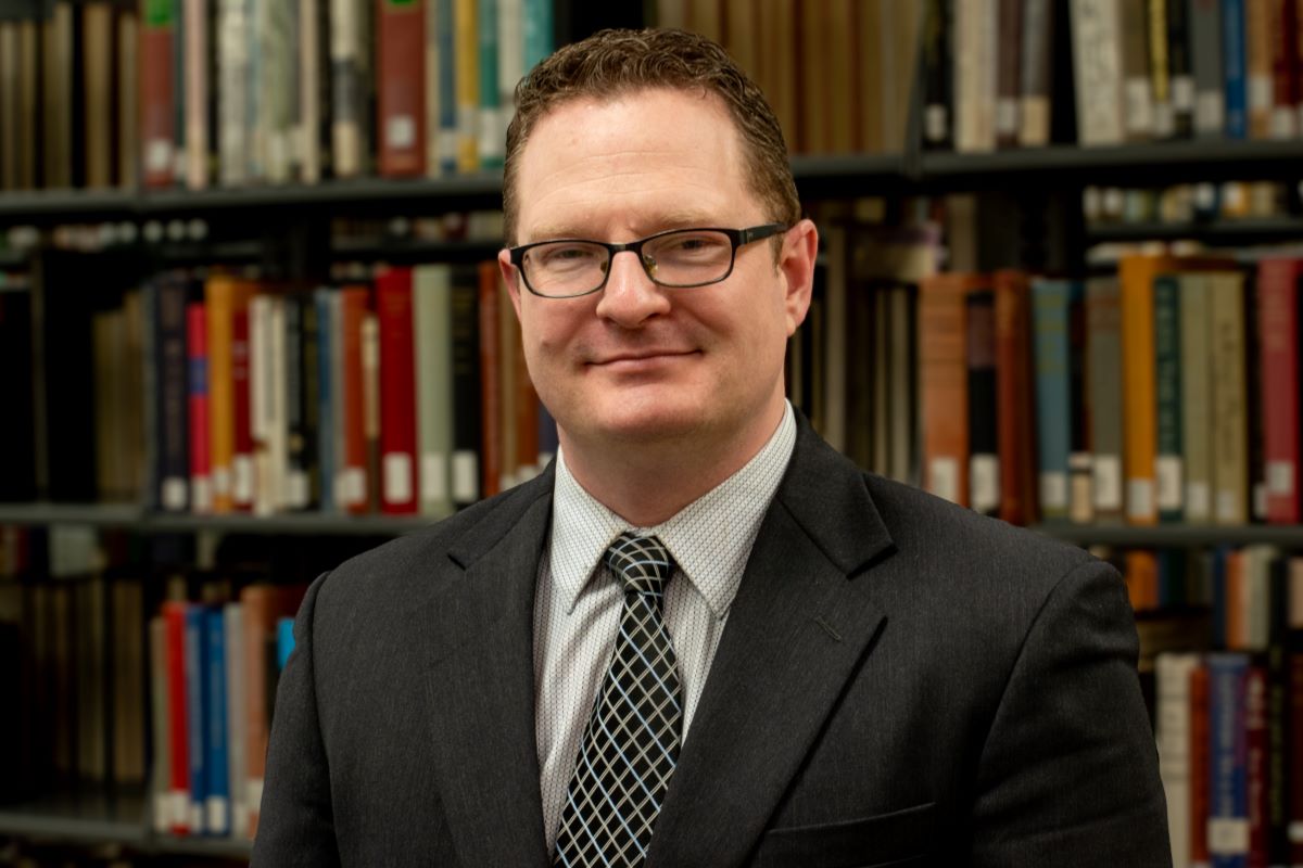 Colin McGill in a library