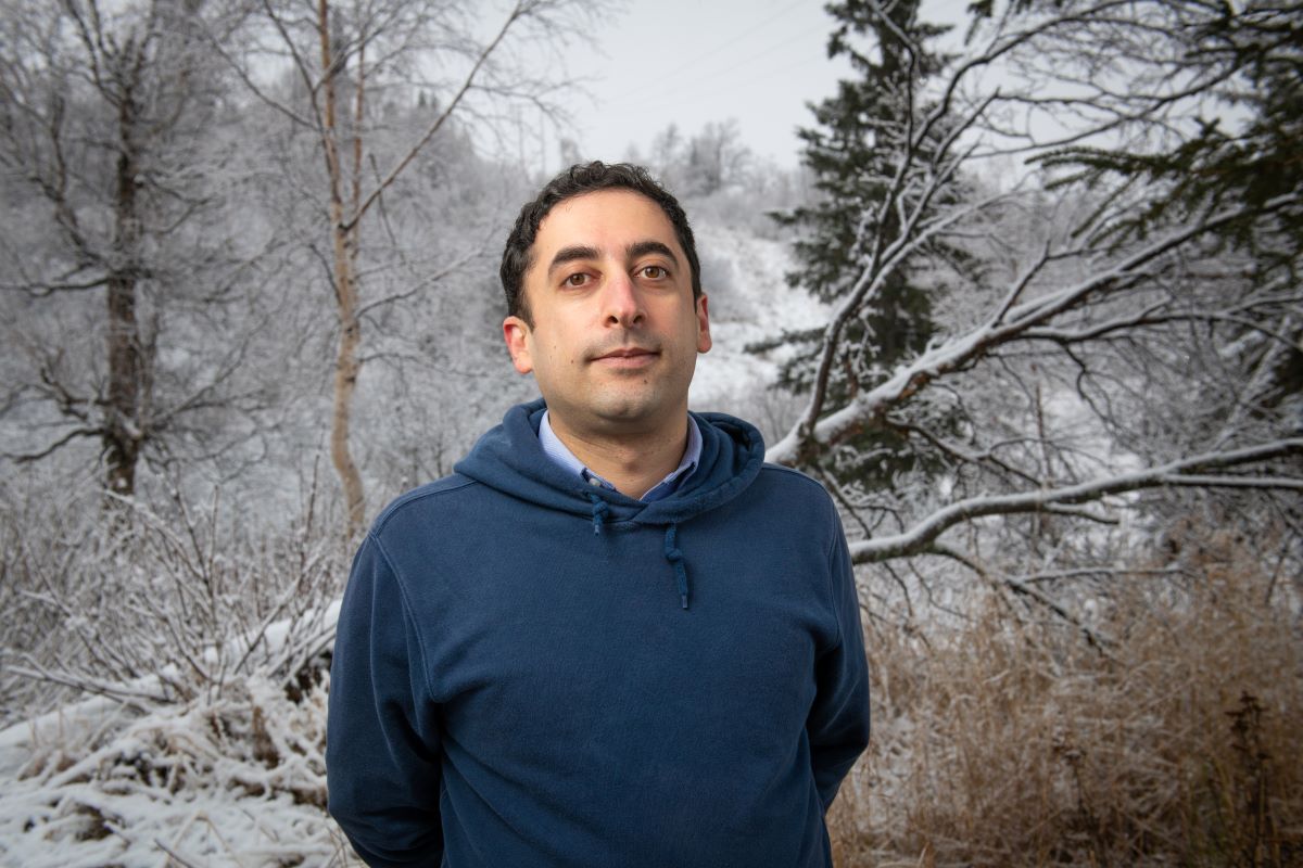 Mohammad Heidari Kapourchali standing near a powerline easement