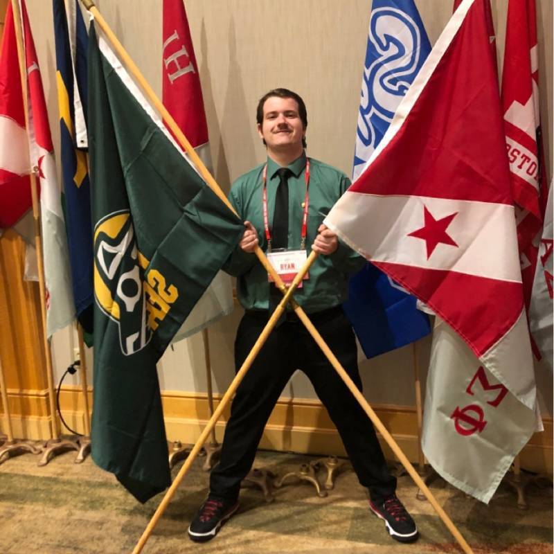 Ryan Phipps raises the Alpha Sigma Phi flag