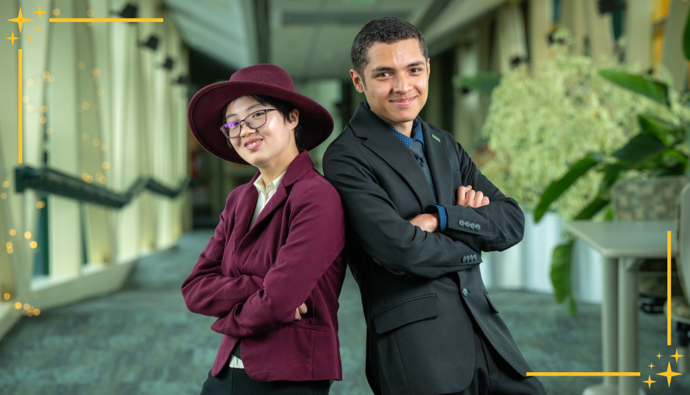 Students president and vice president standing in university hallway.